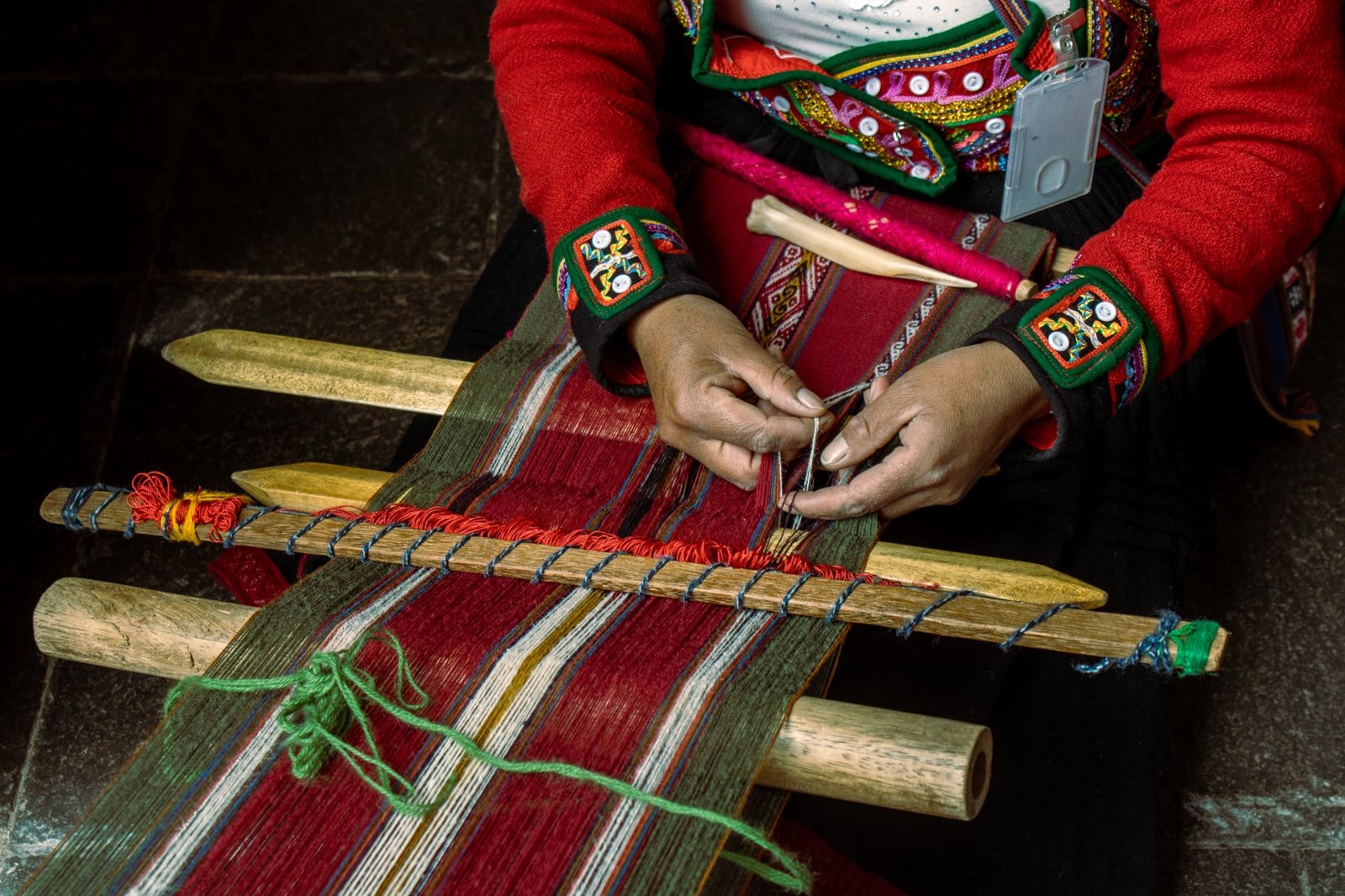Artisan weaving textile by hand
